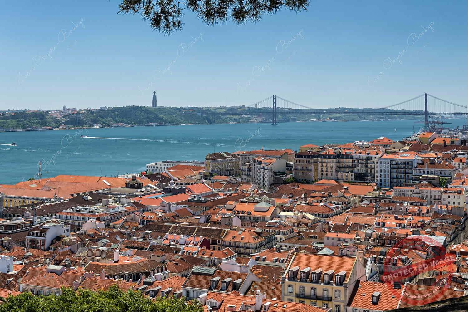 View of Cristo Rei statue and Ponte 25 de Abril in Alfama, Lisbon, Portugal
